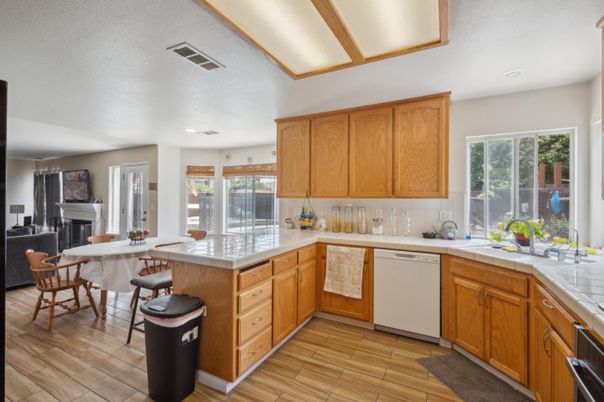 Dining room, Fireplace, Interior, Kitchen, Recessed Lighting, Tile Countertops, Wood Texture Flooring