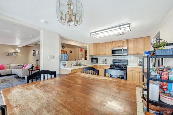 Chandelier, Dining room, Interior, Kitchen, Living room, Stainless Steel Appliances, Wood Texture Flooring