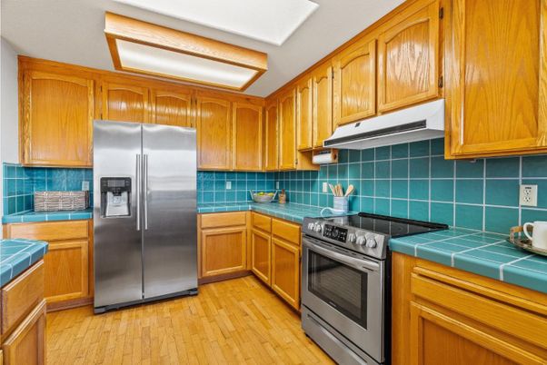 Interior, Kitchen, Stainless Steel Appliances, Tile Countertops, Wood Texture Flooring