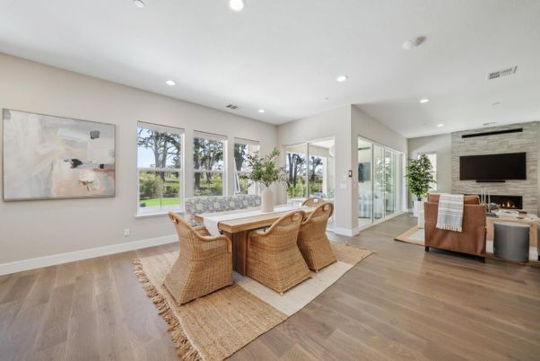 Dining room, Fireplace, Interior, Living room, Recessed Lighting, Stone Walls, Wood Texture Flooring