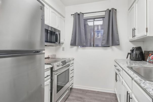 Interior, Kitchen, Stainless Steel Appliances, Tile Countertops, Wood Texture Flooring