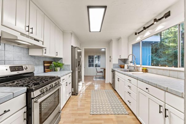 Interior, Kitchen, Stainless Steel Appliances, Tile Countertops, Wood Texture Flooring