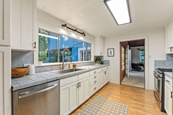 Interior, Kitchen, Stainless Steel Appliances, Tile Countertops, Wood Texture Flooring