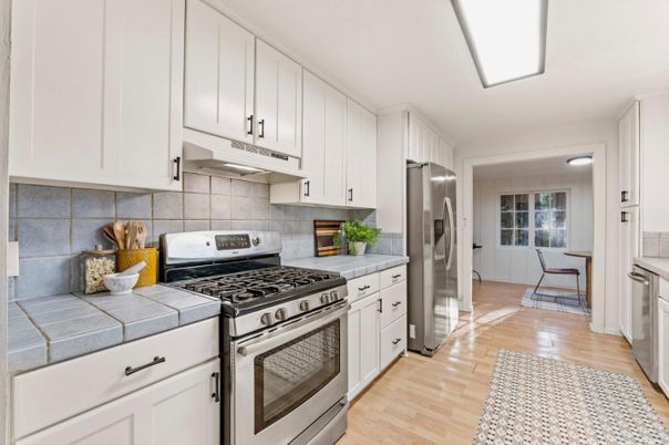 Interior, Kitchen, Stainless Steel Appliances, Tile Countertops, Wood Texture Flooring