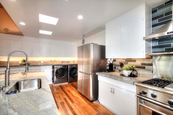 Interior, Kitchen, Recessed Lighting, Stainless Steel Appliances, Tile Countertops, Washer, Wood Texture Flooring