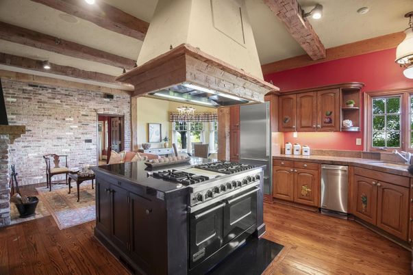 Chandelier, Dining room, Interior, Kitchen, Pendant Lights, Recessed Lighting, Stainless Steel Appliances, Stone Walls, Wooden Beams, Wood Texture Flooring