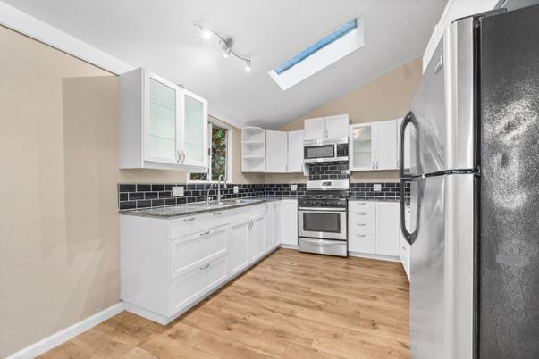 Interior, Kitchen, Stainless Steel Appliances, Tile Countertops, Wood Texture Flooring