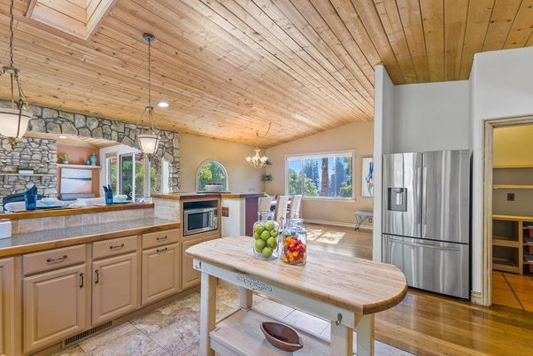Chandelier, Dining room, Interior, Kitchen, Pendant Lights, Recessed Lighting, Stainless Steel Appliances, Stone Walls, Wooden Ceilings, Wood Texture Flooring