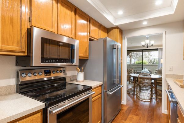 Chandelier, Dining room, Interior, Kitchen, Recessed Lighting, Stainless Steel Appliances, Wood Texture Flooring