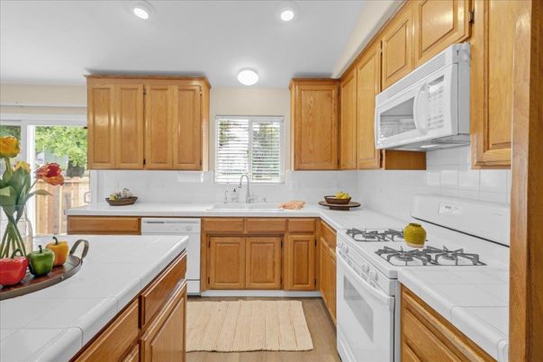 Interior, Kitchen, Recessed Lighting, Tile Countertops, Wood Texture Flooring