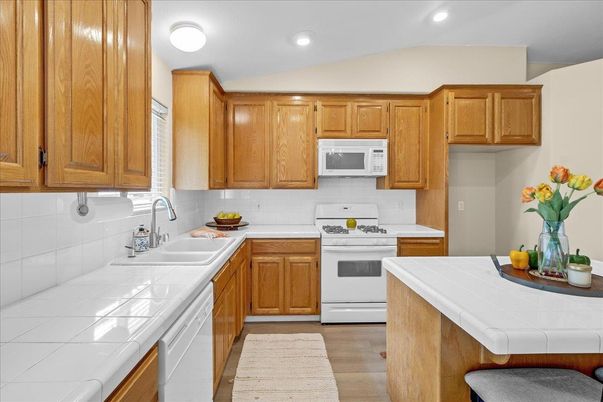Interior, Kitchen, Recessed Lighting, Tile Countertops, Wood Texture Flooring