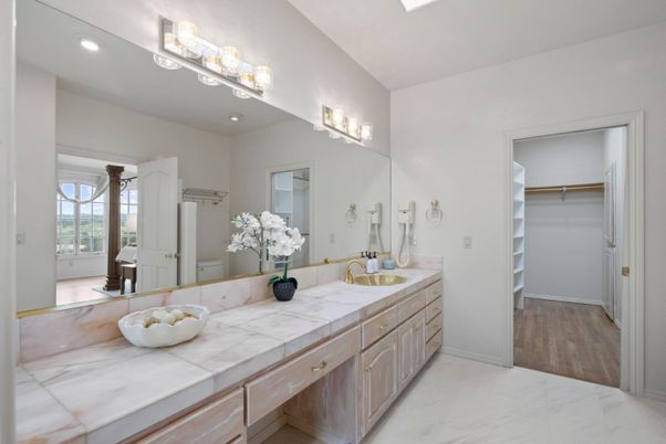 Bathroom, Dual Sink Vanities, Interior, Marble, Recessed Lighting, Tile Countertops, Walk-in Closets, Wood Texture Flooring