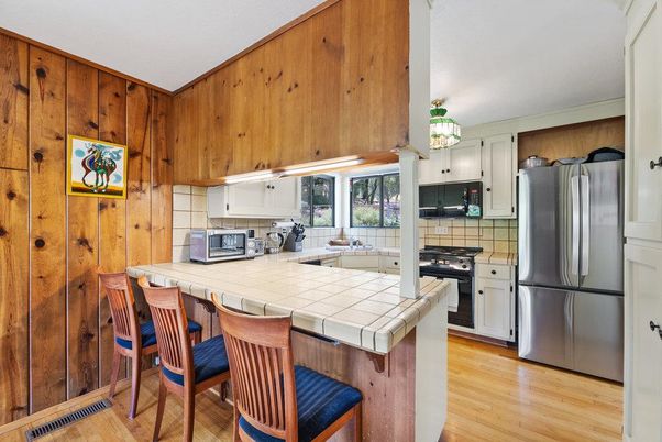 Interior, Kitchen, Tile Countertops, Wood Texture Flooring, Wooden Walls