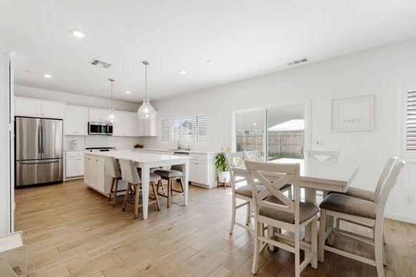 Dining room, Interior, Kitchen, Pendant Lights, Recessed Lighting, Stainless Steel Appliances, Wood Texture Flooring