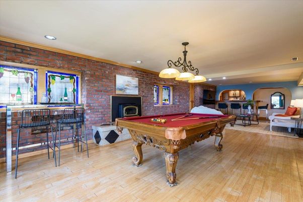 Billiard Table, Chandelier, Fireplace, Game Room, Interior, Recessed Lighting, Stone Walls, Wood Texture Flooring