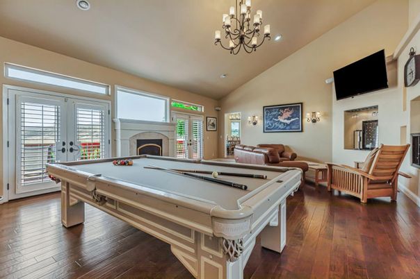 Billiard Table, Chandelier, Fireplace, Game Room, Interior, Living room, Recessed Lighting, Wood Texture Flooring
