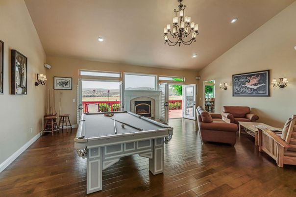 Billiard Table, Chandelier, Fireplace, Game Room, Interior, Living room, Recessed Lighting, Wood Texture Flooring