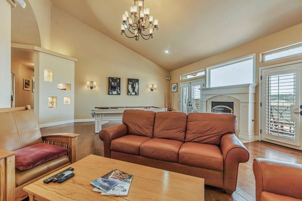 Billiard Table, Chandelier, Fireplace, Game Room, Interior, Living room, Recessed Lighting, Wood Texture Flooring