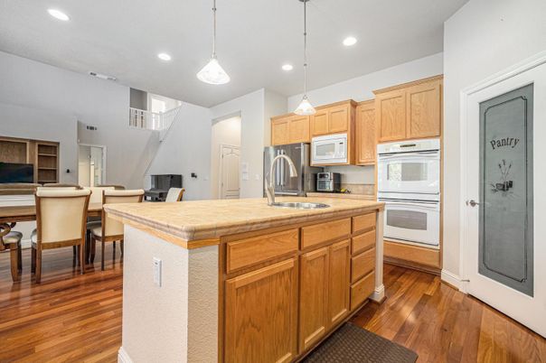 Dining room, Interior, Kitchen, Pendant Lights, Recessed Lighting, Stainless Steel Appliances, Tile Countertops, Wood Texture Flooring
