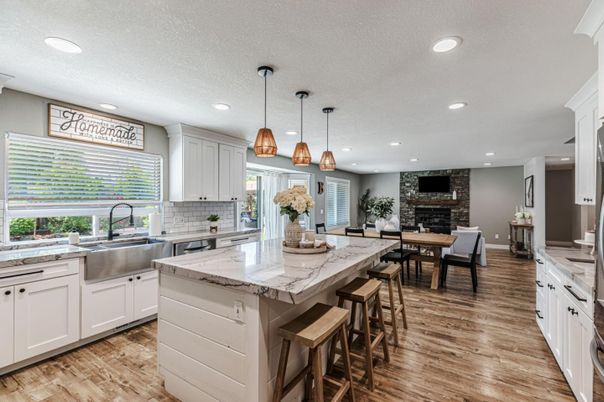 Dining room, Fireplace, Interior, Kitchen, Pendant Lights, Recessed Lighting, Stainless Steel Appliances, Stone Walls, Wood Texture Flooring
