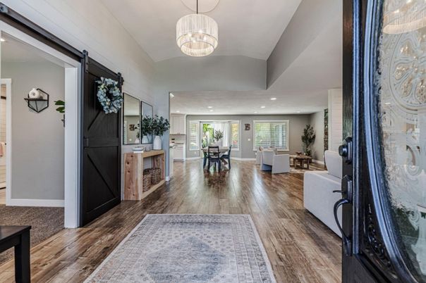 Chandelier, Dining room, Fireplace, Interior, Living room, Pendant Lights, Recessed Lighting, Wood Texture Flooring