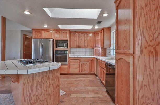 Interior, Kitchen, Recessed Lighting, Stainless Steel Appliances, Tile Countertops, Wood Texture Flooring