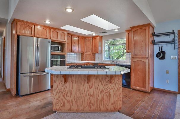 Interior, Kitchen, Recessed Lighting, Stainless Steel Appliances, Tile Countertops, Wood Texture Flooring
