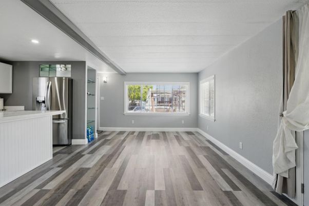 Empty room, Interior, Kitchen, Recessed Lighting, Stainless Steel Appliances, Wood Texture Flooring