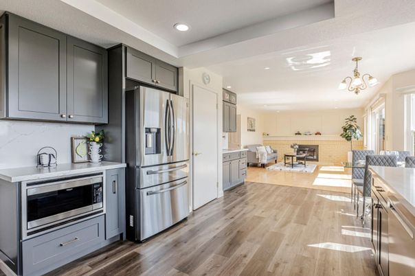 Chandelier, Interior, Kitchen, Living room, Recessed Lighting, Stainless Steel Appliances, Wood Texture Flooring