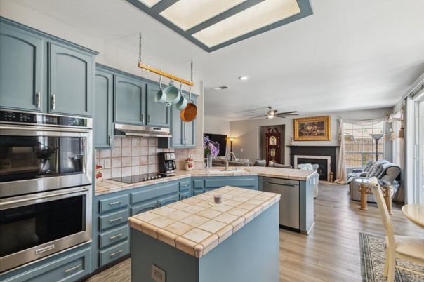 Interior, Kitchen, Recessed Lighting, Stainless Steel Appliances, Tile Countertops, Wood Texture Flooring