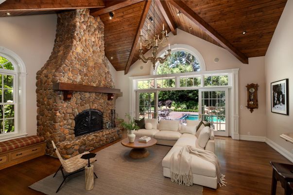 Chandelier, Fireplace, Interior, Living room, Recessed Lighting, Stone Walls, Wooden Beams, Wooden Ceilings, Wood Texture Flooring