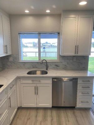 Interior, Kitchen, Marble Walls, Recessed Lighting, Stainless Steel Appliances, Wood Texture Flooring
