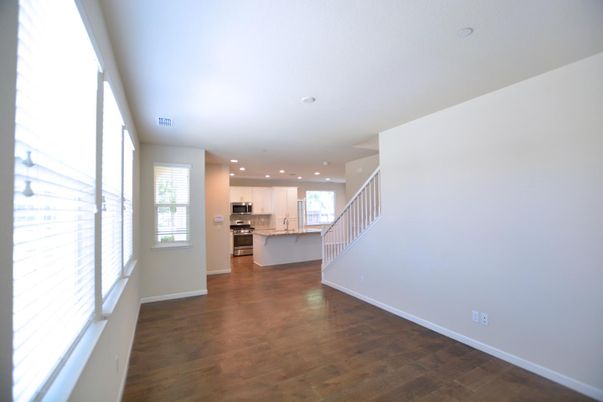 Empty room, Interior, Kitchen, Recessed Lighting, Stainless Steel Appliances, Wood Texture Flooring