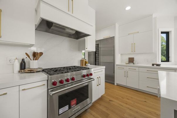 Interior, Kitchen, Marble Walls, Recessed Lighting, Stainless Steel Appliances, Wood Texture Flooring