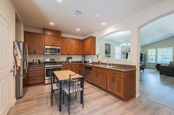 Chandelier, Dining room, Interior, Kitchen, Recessed Lighting, Stainless Steel Appliances, Wood Texture Flooring