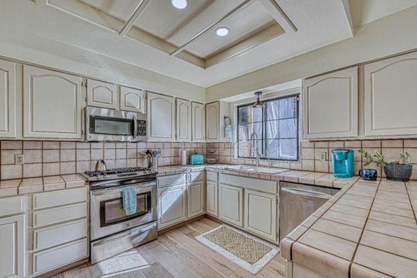 Interior, Kitchen, Recessed Lighting, Tile Countertops, Wood Texture Flooring