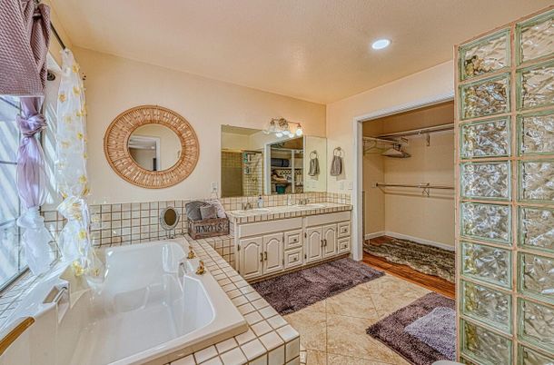Bathroom, Dual Sink Vanities, Interior, Recessed Lighting, Tile Countertops, Walk-in Closets, Wood Texture Flooring