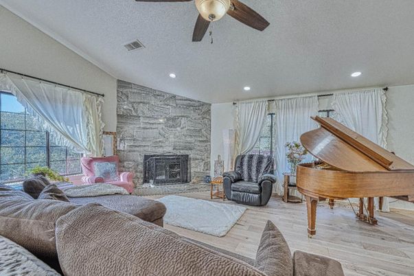 Fireplace, Interior, Living room, Piano, Recessed Lighting, Stone Walls, Wood Texture Flooring