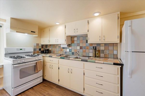 Interior, Kitchen, Recessed Lighting, Tile Countertops, Wood Texture Flooring