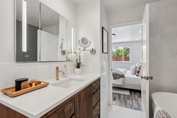 Bathroom, Dual Sink Vanities, Interior, Marble Walls, Recessed Lighting, Wood Texture Flooring