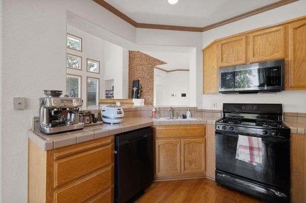 Interior, Kitchen, Recessed Lighting, Tile Countertops, Wood Texture Flooring