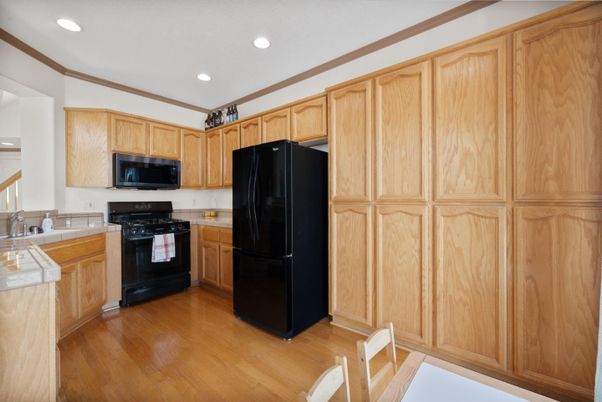 Interior, Kitchen, Recessed Lighting, Tile Countertops, Wood Texture Flooring
