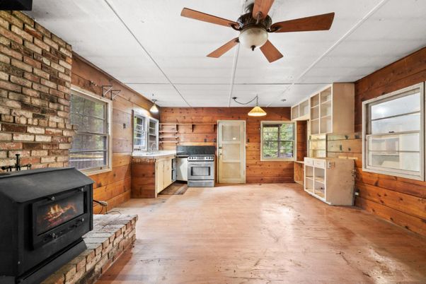 Empty room, Fireplace, Interior, Kitchen, Pendant Lights, Stone Walls, Wood Texture Flooring, Wooden Walls