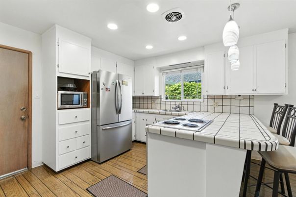 Interior, Kitchen, Recessed Lighting, Tile Countertops, Wood Texture Flooring
