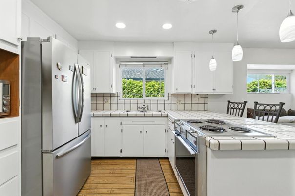 Interior, Kitchen, Pendant Lights, Recessed Lighting, Stainless Steel Appliances, Tile Countertops, Wood Texture Flooring