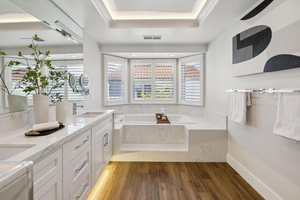 Bathroom, Dual Sink Vanities, Glass Shower, Interior, Marble Walls, Recessed Lighting, Wood Texture Flooring
