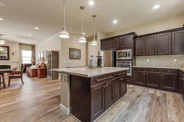 Dining room, Fireplace, Interior, Kitchen, Pendant Lights, Recessed Lighting, Stainless Steel Appliances, Wood Texture Flooring