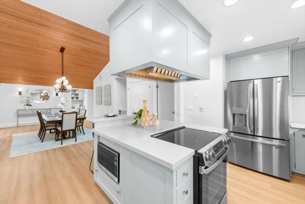 Chandelier, Dining room, Interior, Kitchen, Pendant Lights, Recessed Lighting, Stainless Steel Appliances, Wooden Ceilings, Wood Texture Flooring