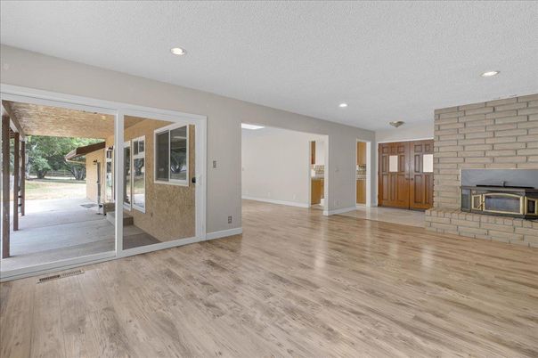 Empty room, Fireplace, Interior, Recessed Lighting, Stone Walls, Wood Texture Flooring