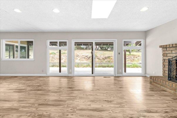 Empty room, Fireplace, Interior, Recessed Lighting, Stone Walls, Wood Texture Flooring
